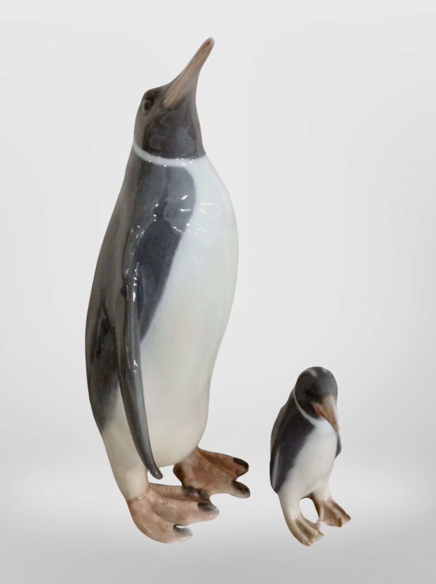 Two Royal Copenhagen figures of penguins, tallest 23cm.