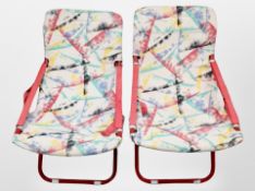 A pair of 20th century folding metal framed chairs with fabric sling seats