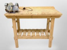 An early 20th century pine work shop bench fitted with a disc grinder,