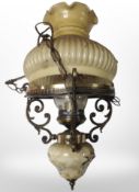 A Danish brass pendant light fitting with opaque glass shade.