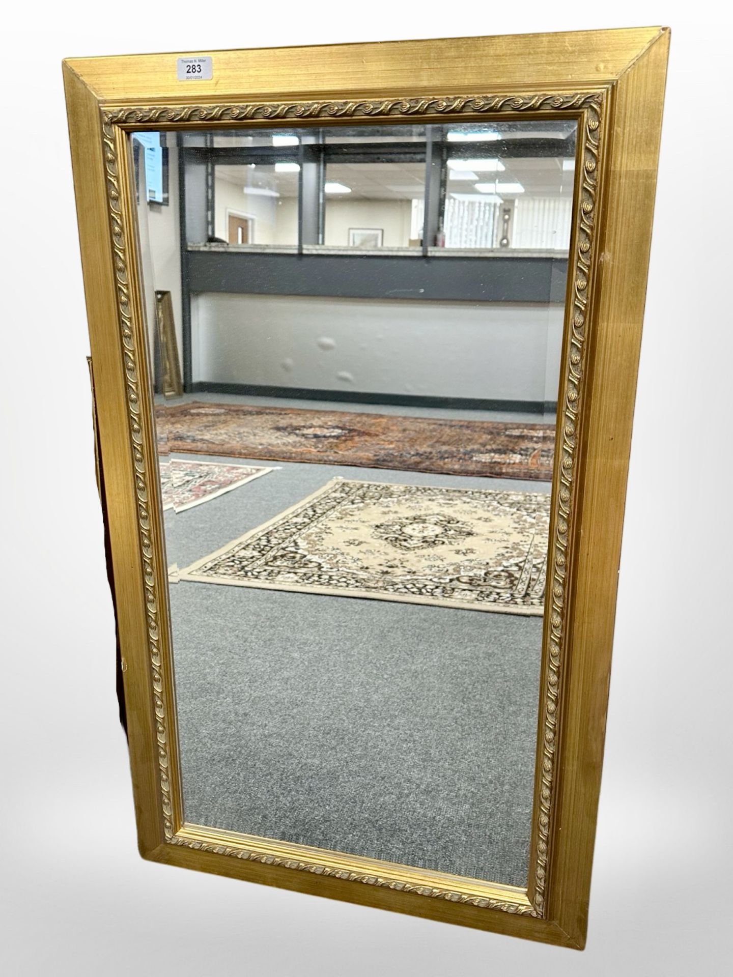 A contemporary bevelled mirror, 59cm x 99cm.