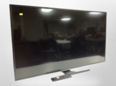 A Hitachi 50 inch LCD TV with lead and remote