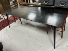 A 20th century Danish ebonised rectangular dining table on flared tapered legs,