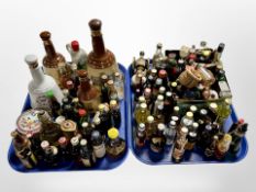 A large collection of alcohol miniatures, several empty ceramic whiskey decanters.