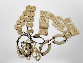 A group of carved bone necklaces,
