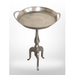 A chrome tripod table,