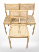 A set of three 20th century beech and cane dining chairs