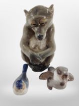 A Royal Copenhagen figure of a bear, height 13cm, a Bing and Grøndahl bird, and one other (3).