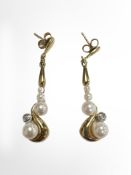A pair of 9ct yellow gold pearl and diamond set earrings. CONDITION REPORT: 5.