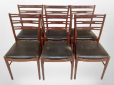 A set of six reproduction teak ladder back dining chairs with black vinyl seats