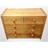 A contemporary pine five drawer low chest,