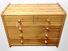 A contemporary pine five drawer low chest,