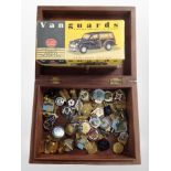 A brass inlaid box containing assorted pin badges and a Vanguards diecast Morris Minor Traveller in