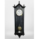 An ebonised Vienna style wall clock with enameled dial, height 118 cm.