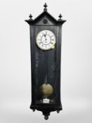 An ebonised Vienna style wall clock with enameled dial, height 118 cm.