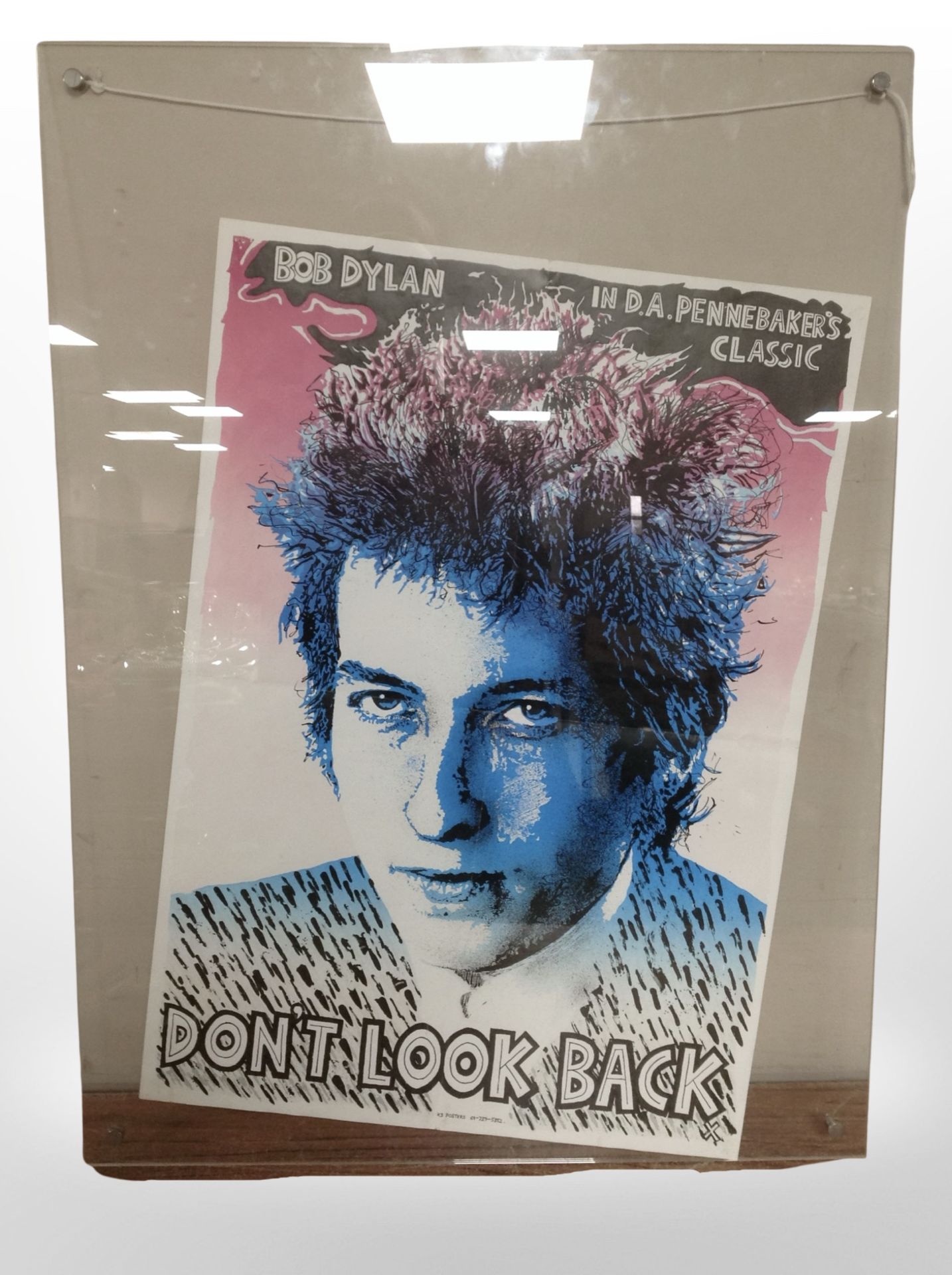 A Bob Dylan poster in perspex frame, 80cm x 58cm overall.