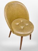 A 1970's Danish tan vinyl chair on tapered teak legs