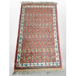 An Iranian rug, 142cm x 76cm.