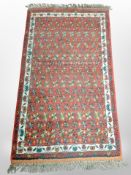 An Iranian rug, 142cm x 76cm.