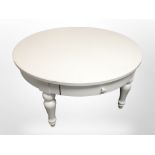 A white MDF circular low coffee table,