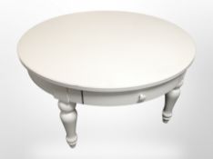 A white MDF circular low coffee table,