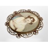 A 19th century portrait miniature of a lady wearing a bonnet in brass scrollwork frame,