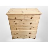 A contemporary pine six drawer chest,