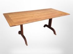 A stained pine rectangular dining table,