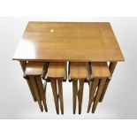 A teak nest of five tables, width 62cm.