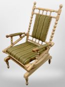 A Danish blond oak bobbin turned rocking chair in striped upholstery