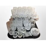 A set of 12 crystal champagne flutes, further set of 7 tumblers, crystal knife rests, etc.