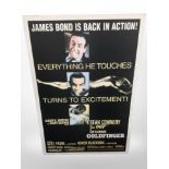 A reproduction James Bond Goldfinger poster, laid to panel,