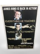 A reproduction James Bond Goldfinger poster, laid to panel,