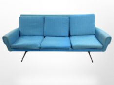 A late 20th century Danish three-seater settee in turquoise fabric raised on chrome legs,