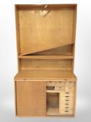 An early 20th century Danish oak and teak sliding door cabinet with compartmentalised interior,