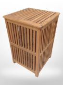 A teak lattice box with hinged lid,