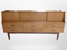 A 1970's teak inverted bow fronted cocktail sideboard,