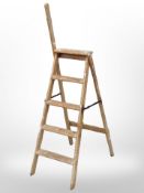 An early 20th century folding pine step ladder