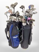 Several golf bags containing assorted irons and drivers including Donnay, Wilson,