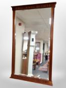 A reproduction mahogany bevelled wall mirror,