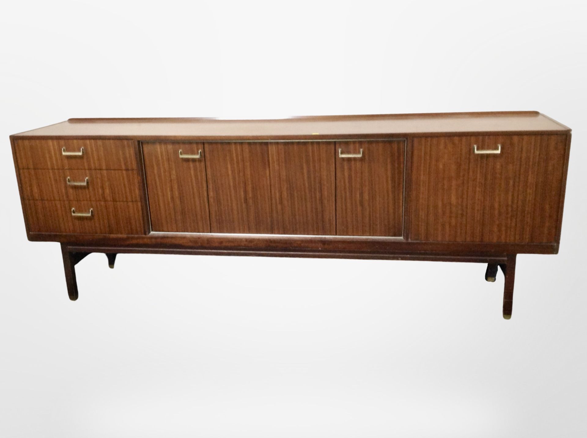 A 1970's teak low sideboard, fitted cupboards and drawers,