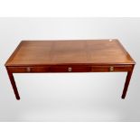 A reproduction mahogany low coffee table, fitted three drawers,