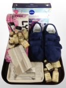 A tray of cosmetic sets, shampoos, leather purses, a pair of slippers.