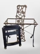 A painted cast iron table base, a further cast iron garden bench back, and a fire grate.