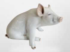 A Royal Copenhagen figure of a seated pig, length 23cm.