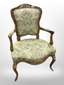 A 19th century continental carved pine and gilt salon armchair in floral upholstery