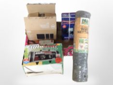 A box containing security light, heater, a roll of chicken wire, etc.