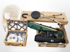 A small wooden bench together with a wicker camper, wicker chair,