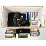 A wicker hamper containing an Original Xbox 360 console and assorted games.