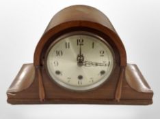 A walnut-cased mantel clock with silvered dial.